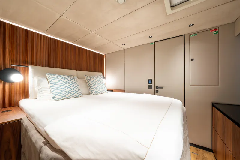  Yacht Photos Pics Luxurious bedroom interior of 2024 Sunreef 60 Eco yacht with modern design and cozy ambiance.