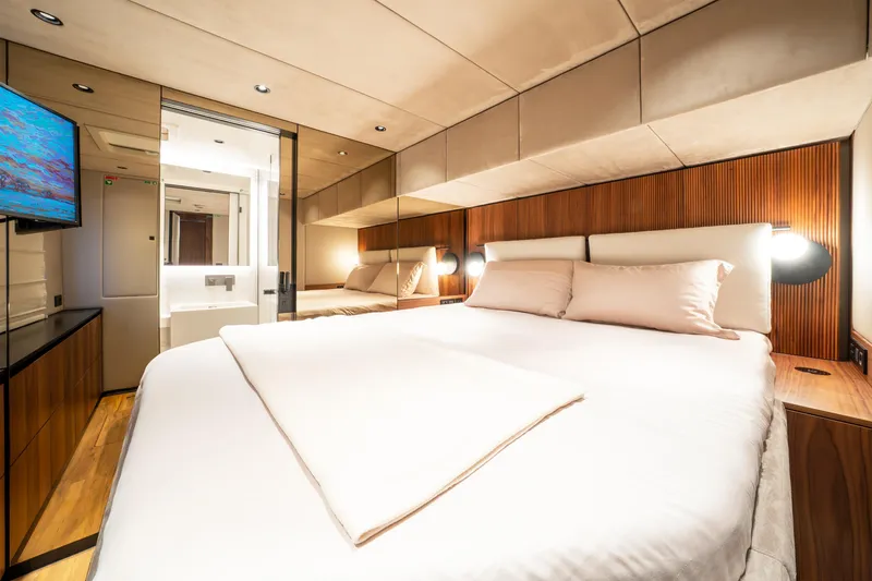  Yacht Photos Pics Luxurious bedroom interior of 2024 Sunreef 60 Eco yacht, featuring modern design and cozy ambiance.