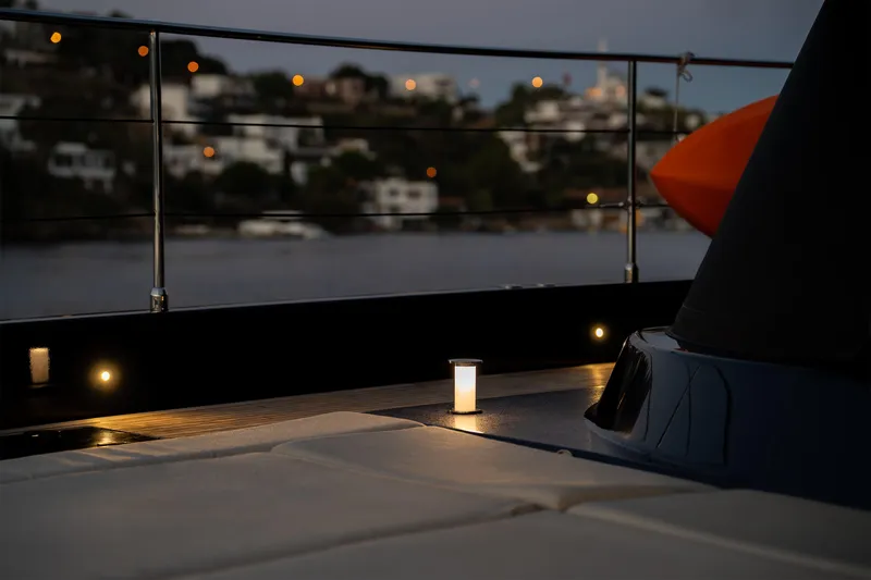  Yacht Photos Pics Luxurious Sunreef 60 Eco yacht deck at dusk, featuring ambient lighting and serene waterfront views.