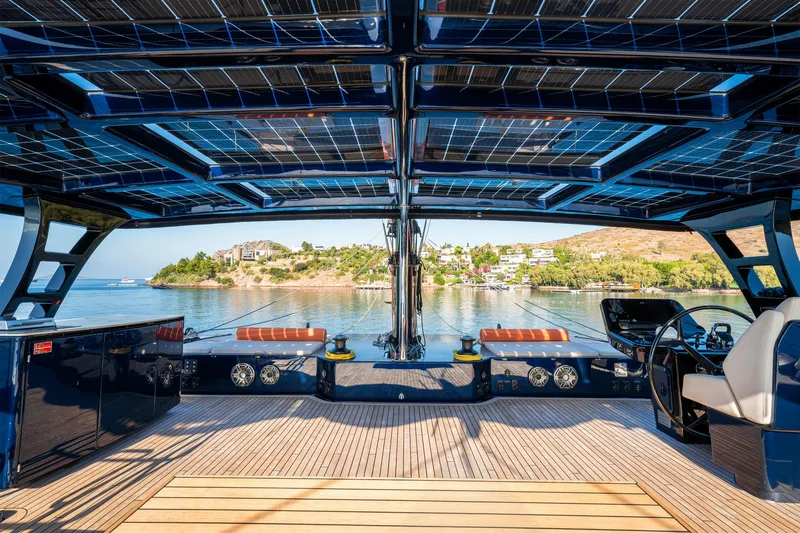  Yacht Photos Pics 2024 Sunreef 60 Eco yacht with solar panels, luxurious deck, and scenic waterfront view.