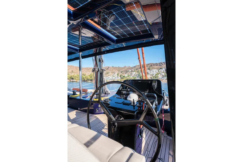  Yacht Photos Pics Helm of 2024 Sunreef 60 Eco yacht with solar panels and scenic marina view.