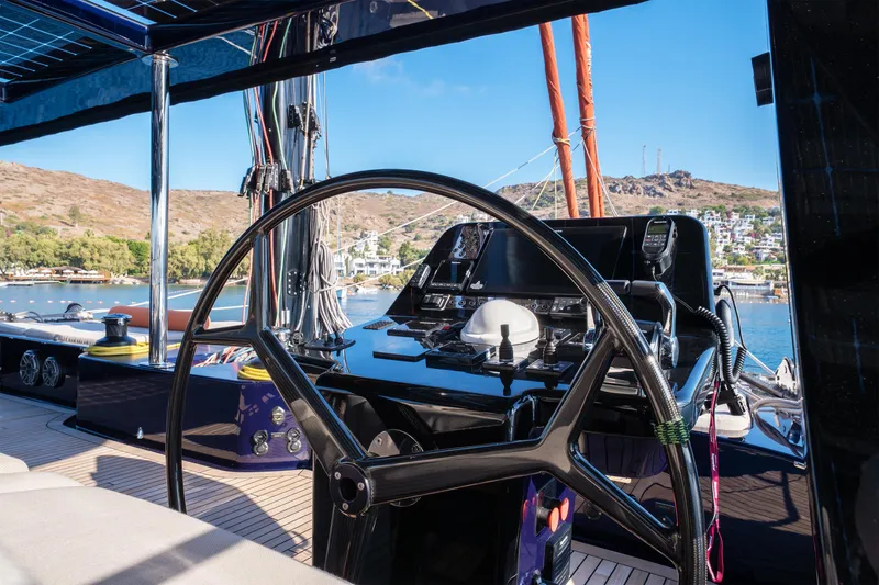  Yacht Photos Pics 2024 Sunreef 60 Eco yacht helm with modern controls, overlooking scenic coastal view.