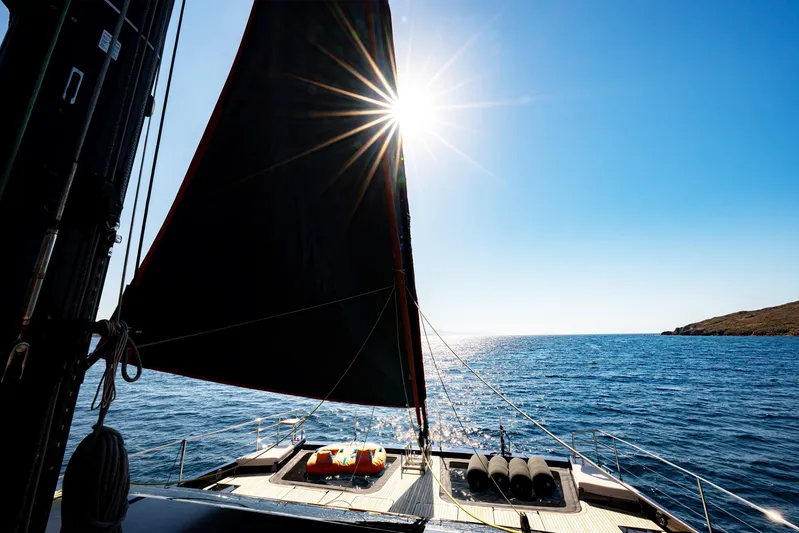  Yacht Photos Pics Sailing on Sunreef 60 Eco yacht, 2024 model, under bright sun and clear blue sky.