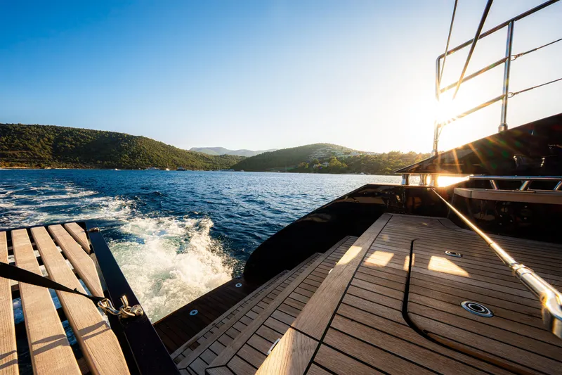  Yacht Photos Pics 2024 Sunreef 60 Eco yacht cruising on a sunny day, scenic coastal view.