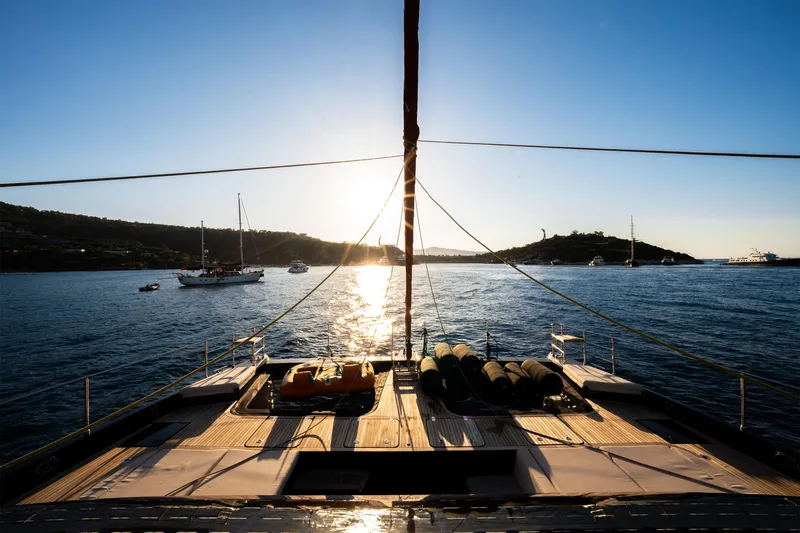  Yacht Photos Pics Sunreef 60 Eco yacht at sunset, 2024 model, overlooking serene ocean and distant islands.