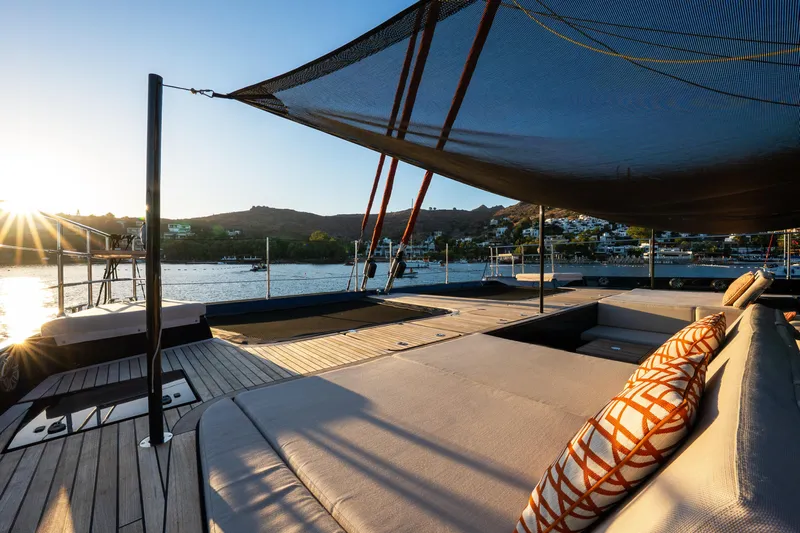  Yacht Photos Pics Luxurious Sunreef 60 Eco yacht deck at sunset, 2024 model, with scenic waterfront view.