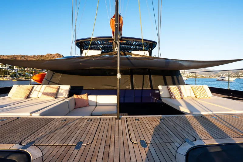  Yacht Photos Pics Luxurious Sunreef 60 Eco yacht deck with elegant seating, 2024 model, docked by scenic coastline.