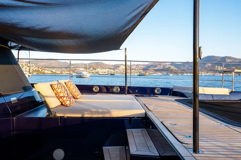  Yacht Photos Pics Luxurious Sunreef 60 Eco yacht deck with cushions, overlooking serene coastal waters, 2024 model.