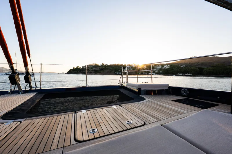  Yacht Photos Pics Luxurious deck of 2024 Sunreef 60 Eco yacht at sunset, overlooking serene waters.