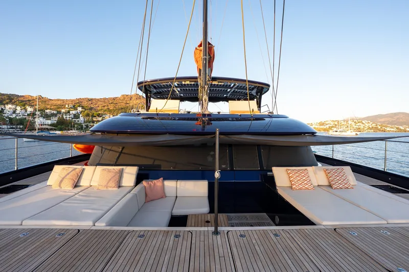  Yacht Photos Pics 2024 Sunreef 60 Eco yacht with spacious deck and luxurious seating, docked in scenic harbor.