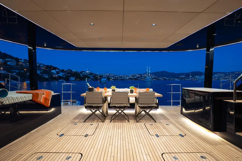  Yacht Photos Pics Luxurious Sunreef 60 Eco yacht deck with elegant dining setup, overlooking serene evening waters.