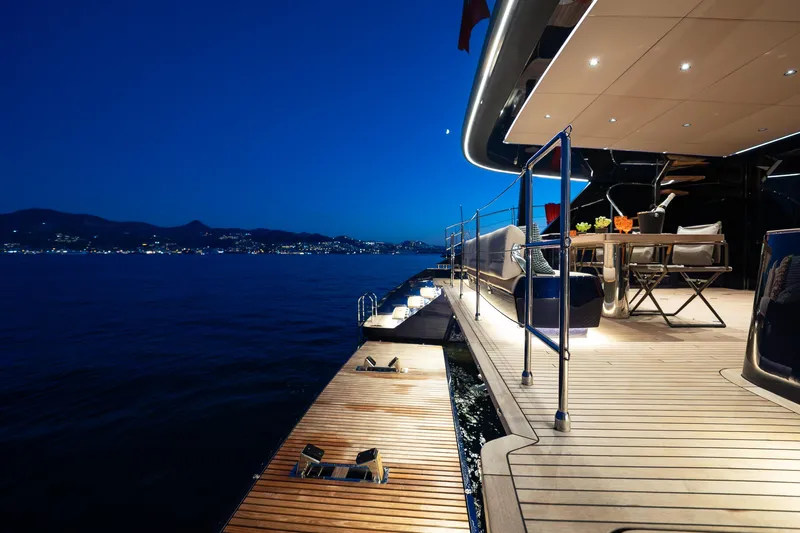  Yacht Photos Pics Luxurious 2024 Sunreef 60 Eco yacht deck at night, overlooking serene ocean view.