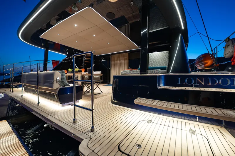  Yacht Photos Pics 2024 Sunreef 60 Eco yacht deck at dusk, featuring elegant seating and ambient lighting.