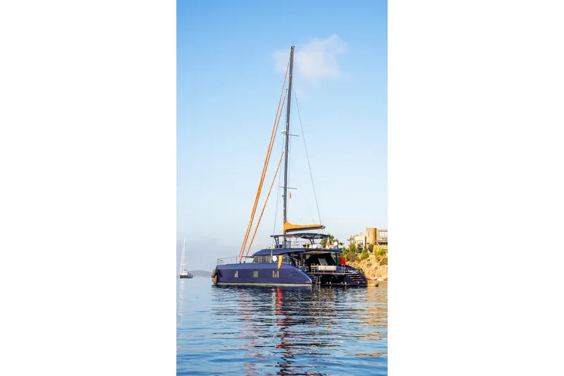  Yacht Photos Pics 2024 Sunreef 60 Eco yacht on calm water, clear sky background.