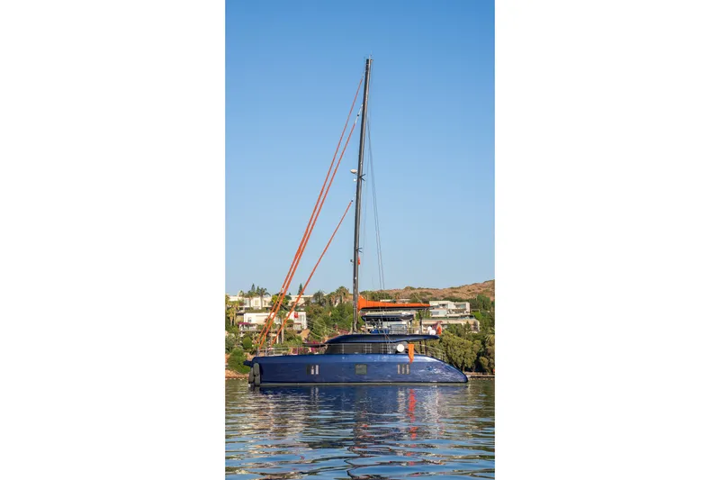  Yacht Photos Pics 2024 Sunreef 60 Eco yacht on calm water, clear blue sky background.