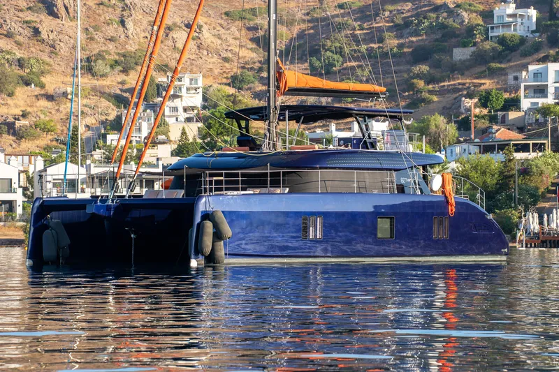  Yacht Photos Pics 2024 Sunreef 60 Eco catamaran in a scenic coastal setting.