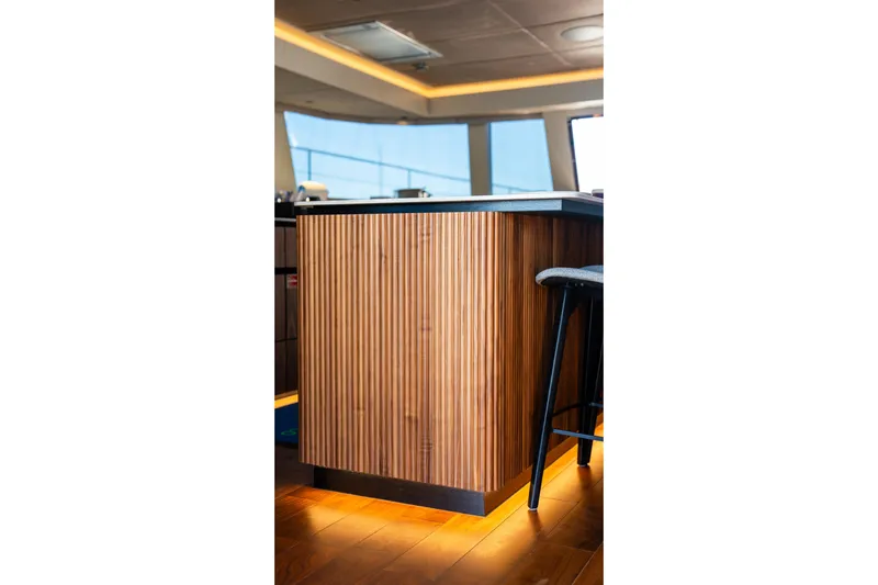  Yacht Photos Pics Modern interior of 2024 Sunreef 60 Eco yacht with wooden paneling and ambient lighting.