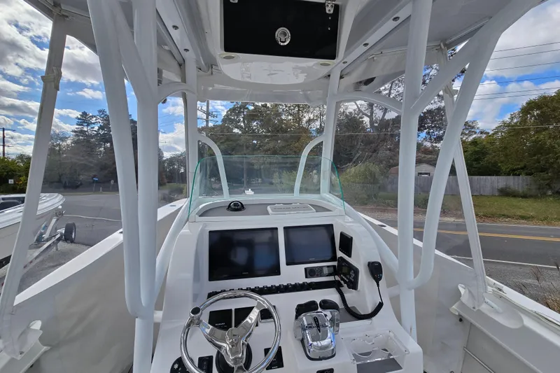  Yacht Photos Pics 2021 Twin Vee 310 CC GF boat cockpit with modern controls and steering wheel.