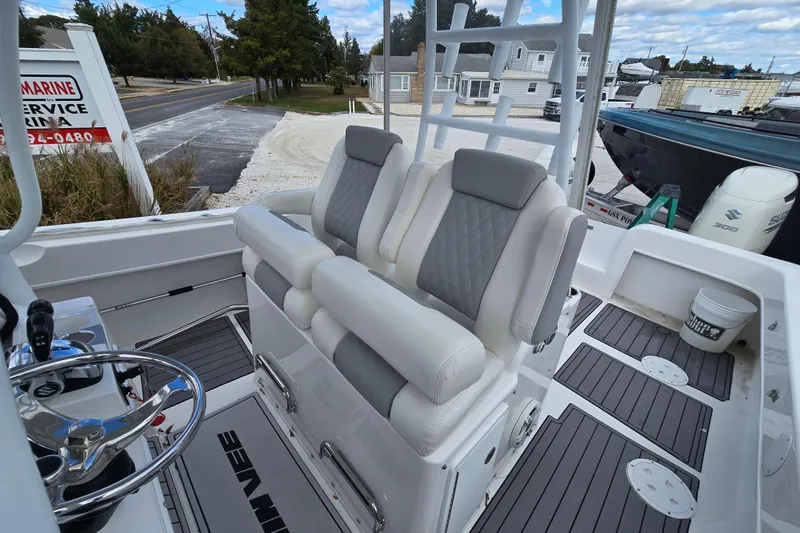  Yacht Photos Pics 2021 Twin Vee 310 CC GF boat interior with cushioned seating and steering wheel.