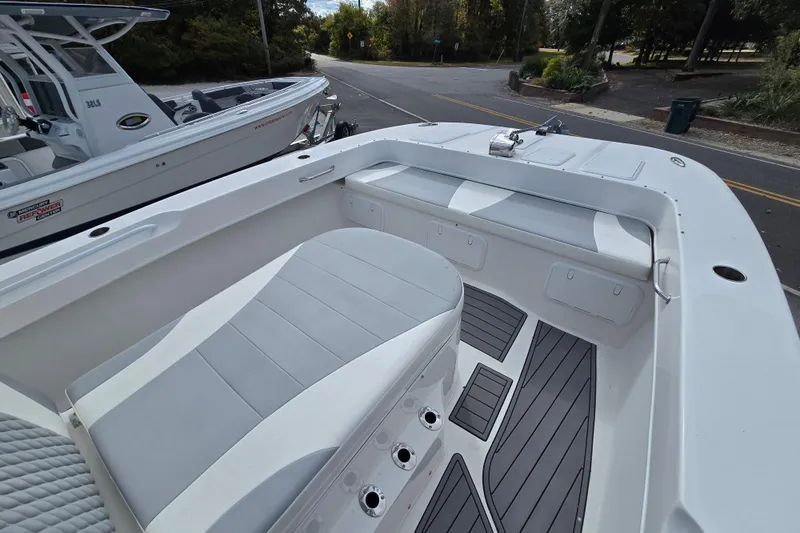  Yacht Photos Pics 2021 Twin Vee 310 CC GF boat interior with cushioned seating and storage compartments.