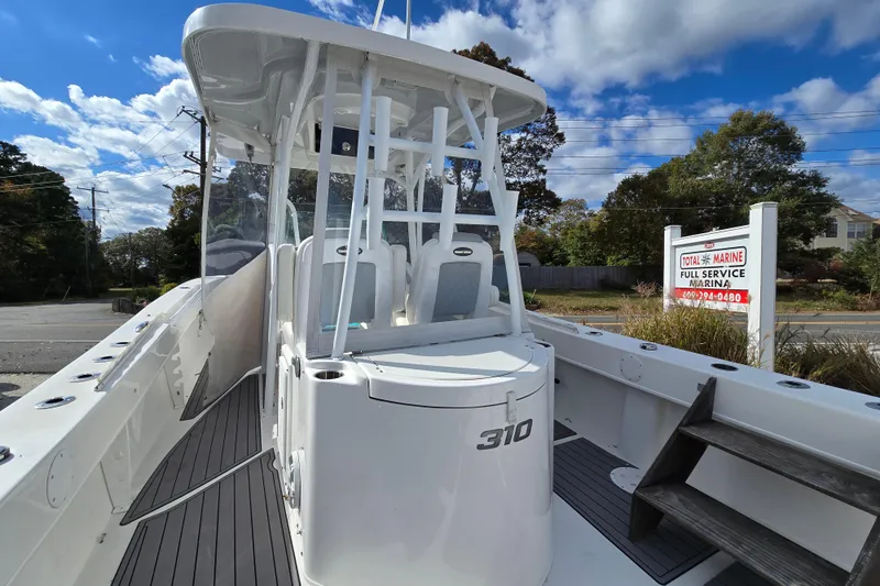  Yacht Photos Pics 2021 Twin Vee 310 CC GF boat at marina under blue sky.