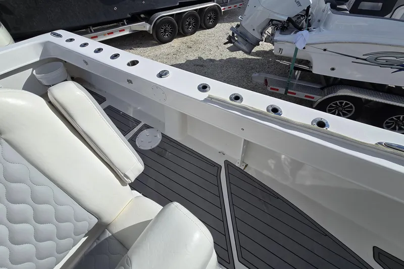  Yacht Photos Pics 2021 Twin Vee 310 CC GF boat interior with white seating and rod holders.