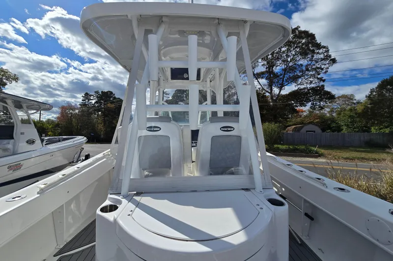  Yacht Photos Pics 2021 Twin Vee 310 CC GF boat with sleek design, viewed from the front under a cloudy sky.