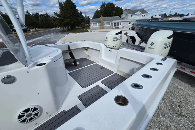  Yacht Photos Pics 2021 Twin Vee 310 CC GF boat with dual Suzuki 300 engines, docked on a trailer.