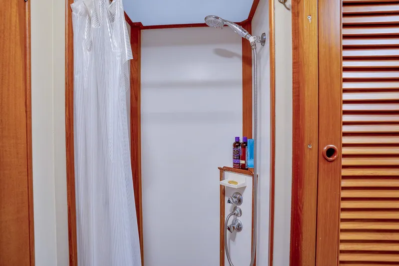 30 West Yacht Photos Pics Shower area in 1991 Grand Banks 49 Classic yacht with wooden accents and toiletries.
