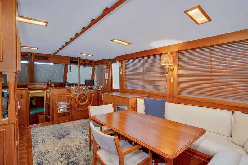 30 West Yacht Photos Pics Interior of 1991 Grand Banks 49 Classic yacht with wooden furnishings and cozy seating area.