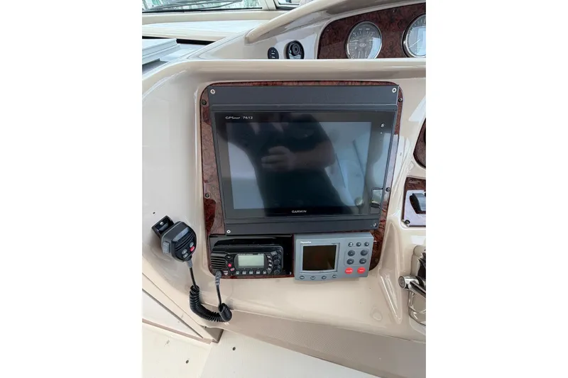  Yacht Photos Pics Control panel of 2004 Sea Ray 480 Sedan Bridge with Garmin GPS and communication devices.