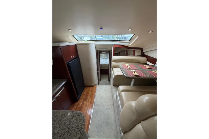  Yacht Photos Pics Interior of 2004 Sea Ray 480 Sedan Bridge yacht with dining area and kitchenette.