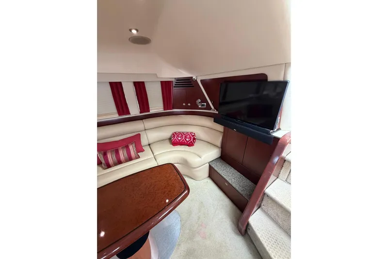  Yacht Photos Pics Luxurious interior of 2004 Sea Ray 480 Sedan Bridge with plush seating and TV.