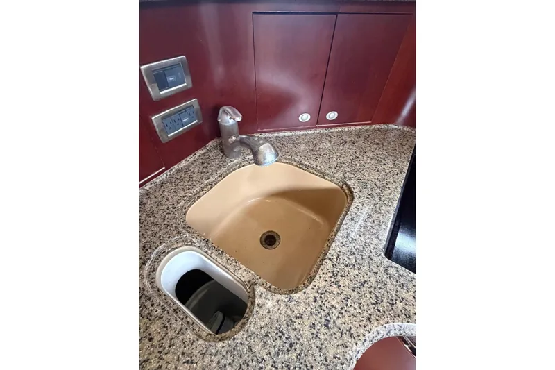  Yacht Photos Pics Granite countertop with sink in 2004 Sea Ray 480 Sedan Bridge yacht kitchen.