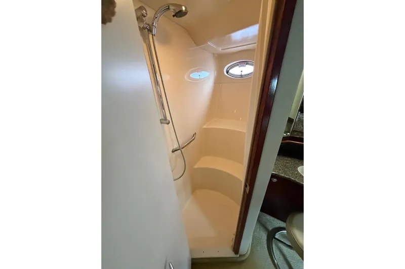  Yacht Photos Pics 2004 Sea Ray 480 Sedan Bridge shower with porthole and chrome fixtures.