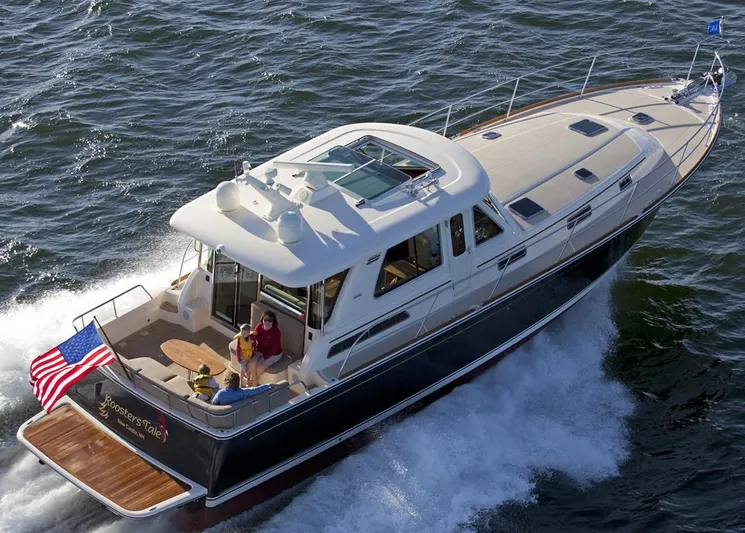 Vertical Yacht Photos Pics 2017 Sabre 48 Salon Express yacht cruising on open water with passengers.