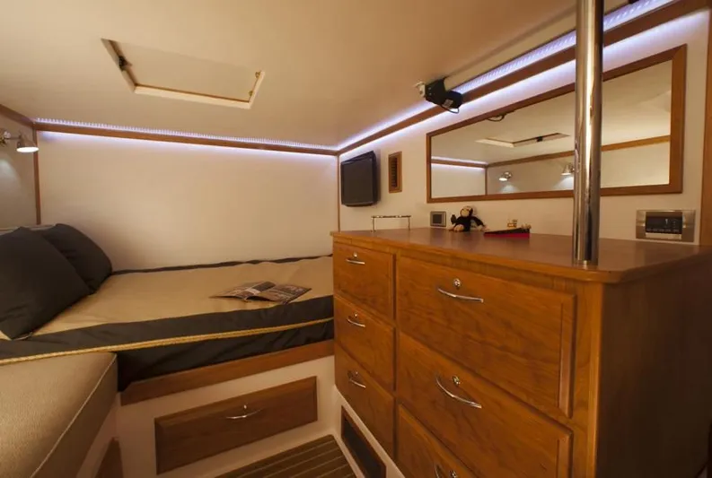 Vertical Yacht Photos Pics Luxurious cabin interior of 2017 Sabre 48 Salon Express yacht with wooden dresser and cozy bed.