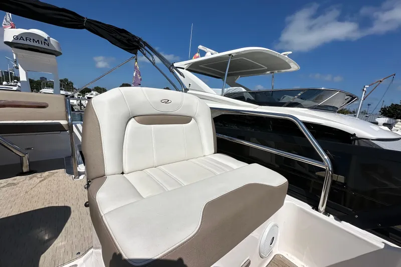  Yacht Photos Pics 2019 Regal 42 Fly yacht with cushioned seating and Garmin equipment under a clear blue sky.
