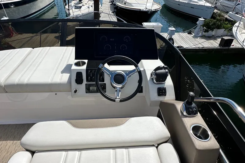  Yacht Photos Pics Flybridge helm of 2019 Regal 42 Fly yacht with modern controls and seating.