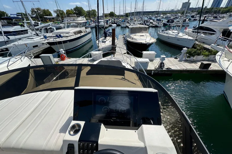  Yacht Photos Pics 2019 Regal 42 Fly yacht at marina, view from helm, surrounded by boats.