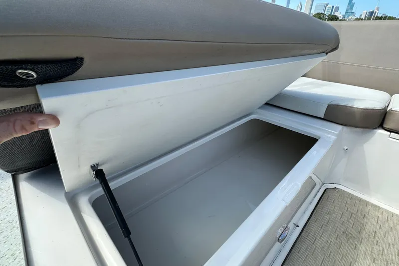  Yacht Photos Pics 2019 Regal 42 Fly boat storage compartment with cushioned seating and open lid.