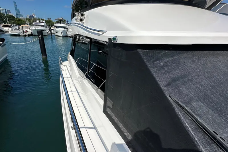  Yacht Photos Pics 2019 Regal 42 Fly yacht docked in marina, surrounded by water and other boats.