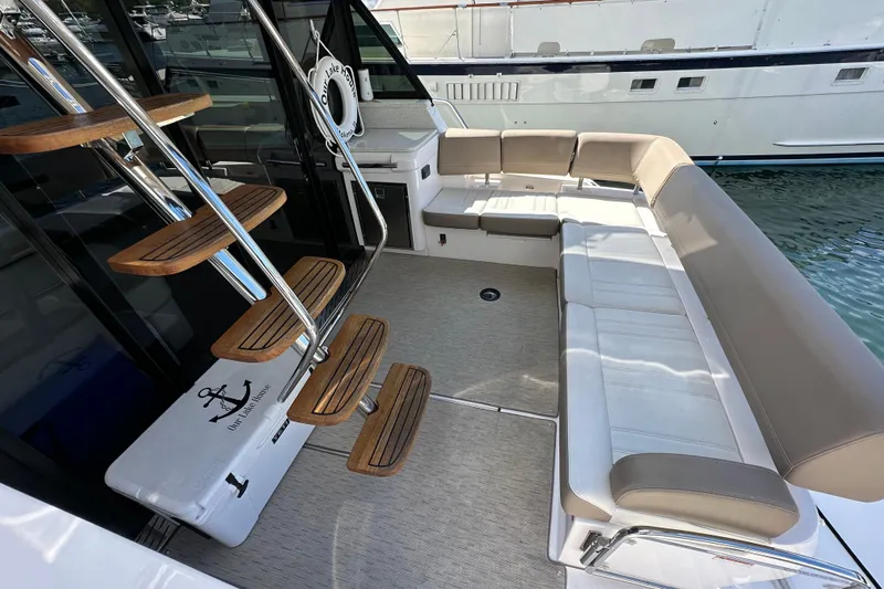  Yacht Photos Pics Luxurious 2019 Regal 42 Fly yacht deck with elegant seating and wooden stairs.