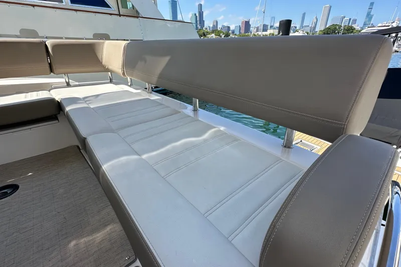  Yacht Photos Pics Luxurious seating on 2019 Regal 42 Fly yacht with city skyline in background.