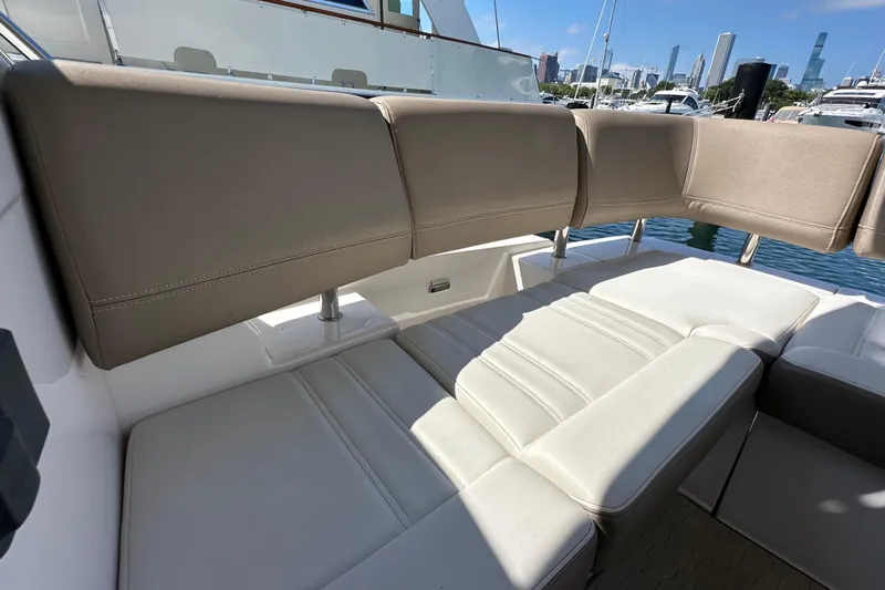  Yacht Photos Pics Luxurious seating on 2019 Regal 42 Fly yacht, docked with city skyline view.