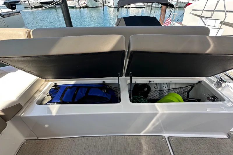  Yacht Photos Pics Open storage compartments on a 2019 Regal 42 Fly yacht, docked at a marina.