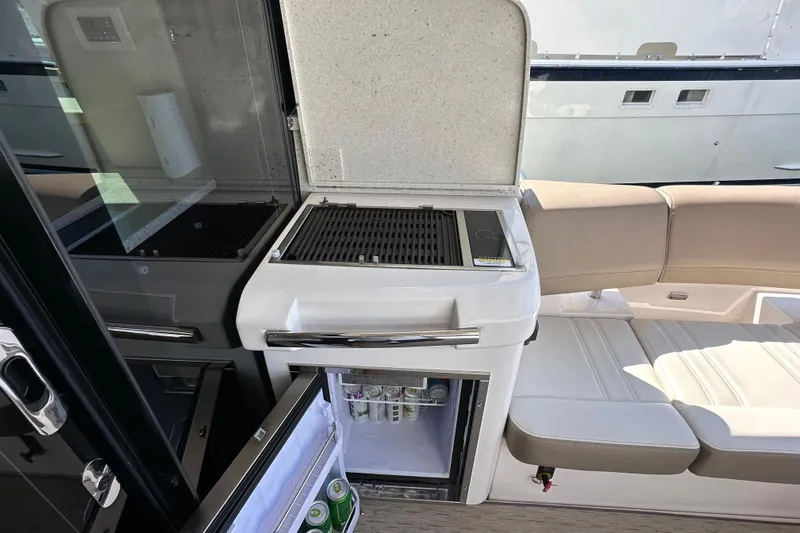  Yacht Photos Pics Outdoor kitchen on 2019 Regal 42 Fly yacht with grill and mini fridge.