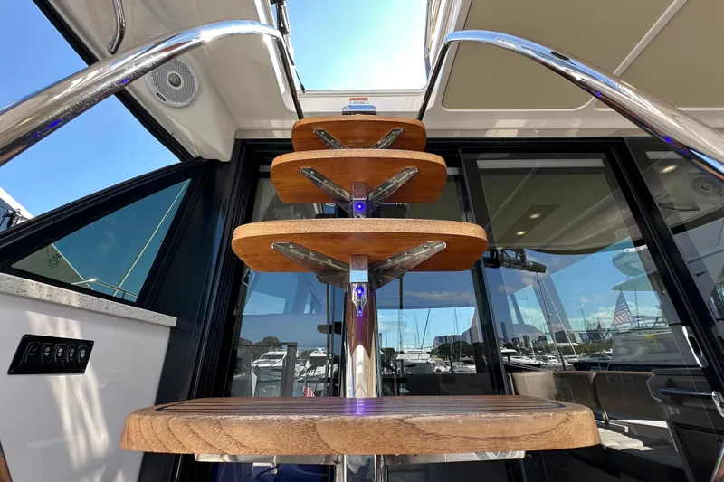  Yacht Photos Pics Staircase on 2019 Regal 42 Fly yacht with wooden steps and metal railings.