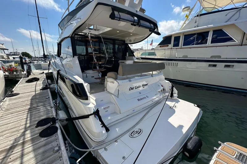  Yacht Photos Pics 2019 Regal 42 Fly yacht docked at marina, rear view with clear sky.
