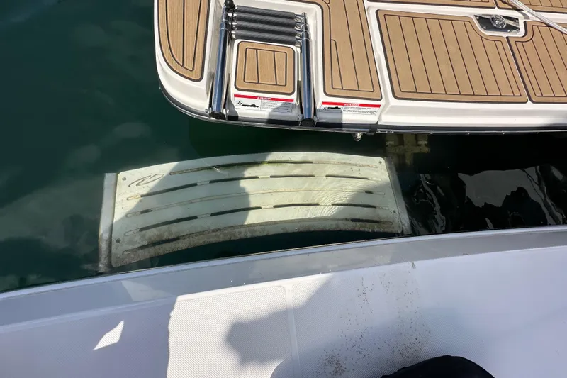  Yacht Photos Pics 2019 Regal 42 Fly swim platform with ladder, docked on calm water.